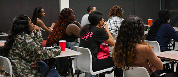 Students actively listening to a guest speaker